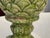 A handsome pair of glazed terracotta finials modeled as stylized artichokes, their overlapping leaves rendered in mottled...