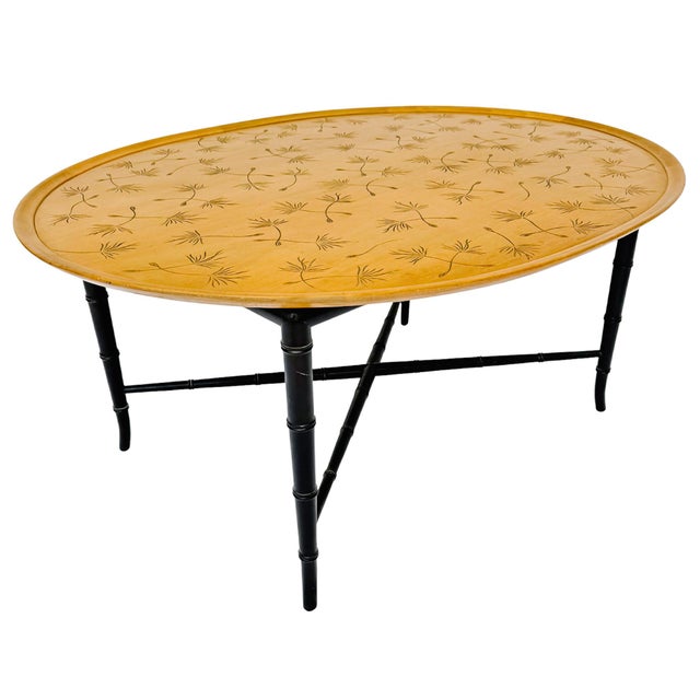 Full of mid-century character, this vintage oval cocktail / coffee table features a whimsical stenciled dandelion seedhead...