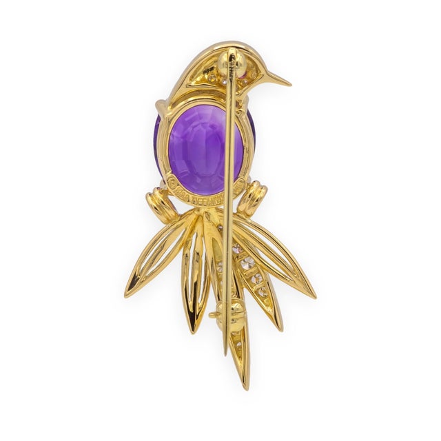 Tiffany & Co. bird of paradise brooch in 18K yellow gold, dated 1988, set with an oval-cut amethyst measuring 10mm x 12mm...