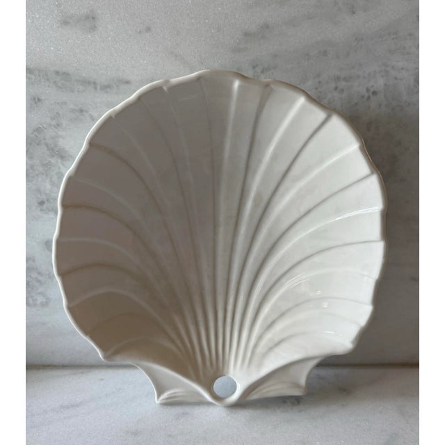 Vintage white glazed ceramic serving platter in the shape of scallop shell. Made in Portugal I believe by Sigma. Marked on...