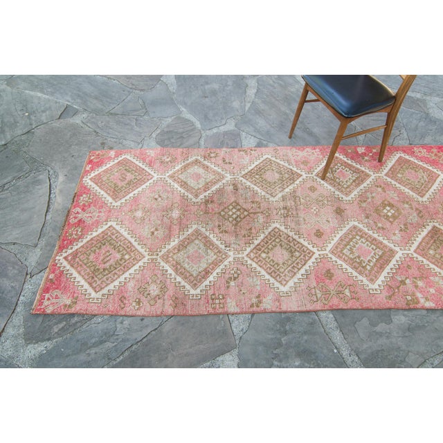 A lovely hand-knotted runner with a diamond medallion design taking center stage. Featuring colors such as dark grapefruit...