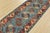 A tribal Caucasian Kazak runner hand-knotted with an all-wool pile on a cotton foundation. This oriental rug features a...