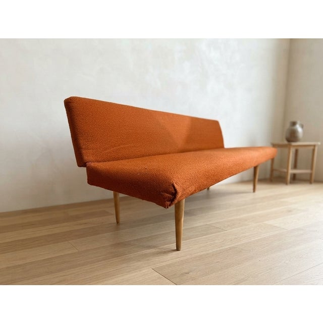 A beautifully designed Mid-Century sofa by Miroslav Navrátil, featuring elegant wooden legs, clean sculptural lines, and...