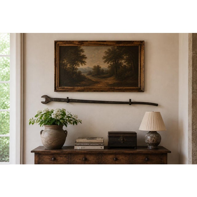 An extraordinary early 20th-century railroad wrench, hand forged from iron on a monumental scale and retaining a deeply...