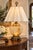A dramatic vintage statement lamp combining luminous amber glass, romantic floral ornament and richly detailed Venetian-...