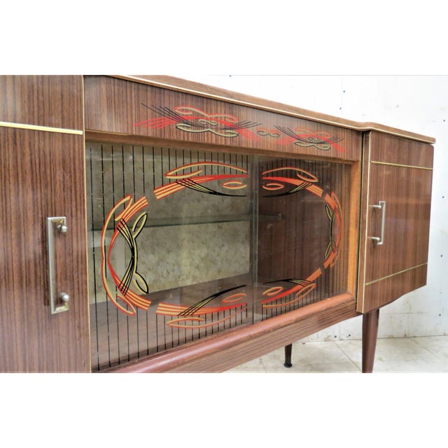 What a wonderful piece for any home with mid century decor. This cocktail cabinet was imported from England. It has a...