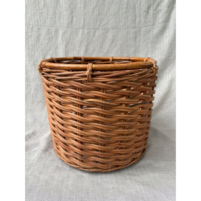 Vintage woven wicker round basket with a rattan top edge. No marks. Very good condition. Basket measures 13 3/4" in...