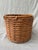 Vintage woven wicker round basket with a rattan top edge. No marks. Very good condition. Basket measures 13 3/4" in...