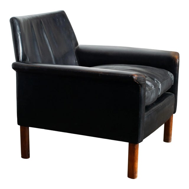 Experience timeless sophistication with our exclusive vintage black-leather armchair. Crafted from a wood frame and...