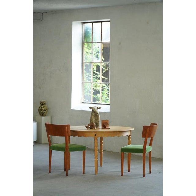 A classic Danish Modern dining table crafted in solid oak, produced by CJ Rosengaarden, Denmark in the 1960s. The table...