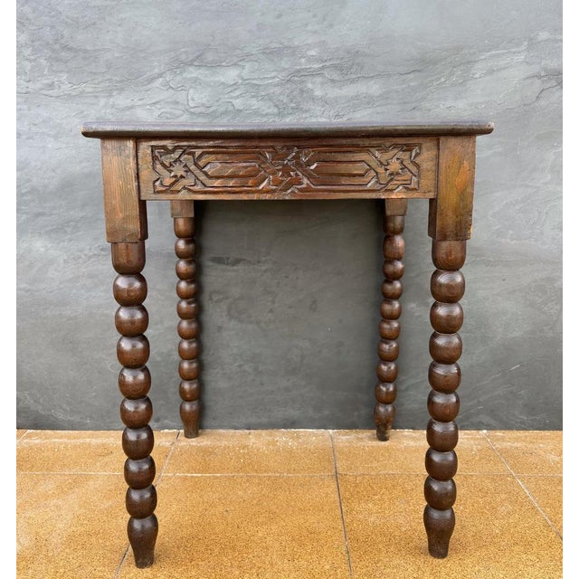 Charming Spanish side table featuring a richly carved geometric top and elegant barley twist legs, a hallmark of Iberian...