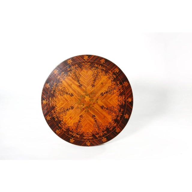 Round shape neoclassical style marquetry top pedestal center table with base worked design details. The table is in great...