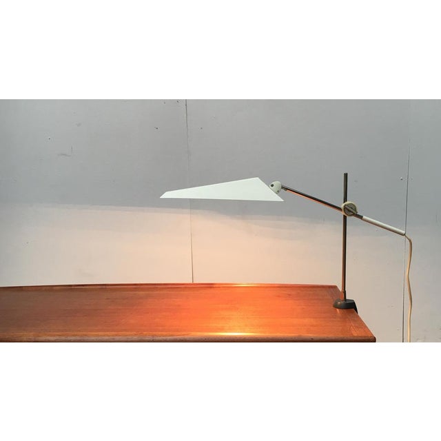 Very rare table lamp from Kaiser Leuchten. A minimalist design. The flat shape of the umbrella with its striking lines and...