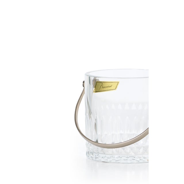 This beautiful crystal ice bucket has vertical cuts on the side with a silver handle. Baccarat was established in France...