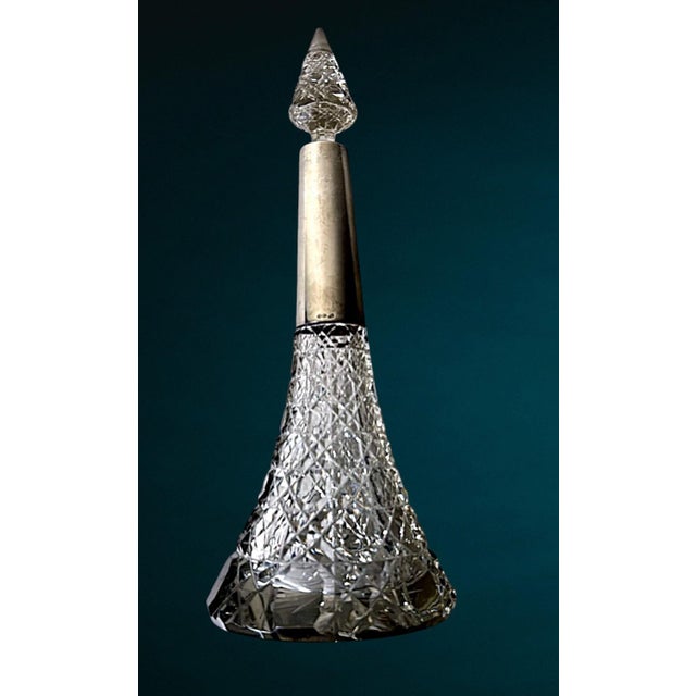 An elegant and sculptural large-sized perfume or cologne bottle, crafted from refined hand-cut crystal and finished with a...