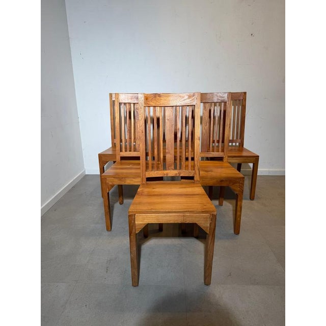 Beautiful set of six dining chairs crafted from solid teak wood. These chairs are made from massive wood, giving them a...