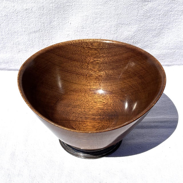 A beautifully sculpted Mid-Century centerpiece bowl crafted from richly figured mahogany and mounted on a sterling silver...