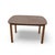 A compact mid-century modern dining table with a walnut-look laminate top arranged in a radiating bookmatch-style pattern...