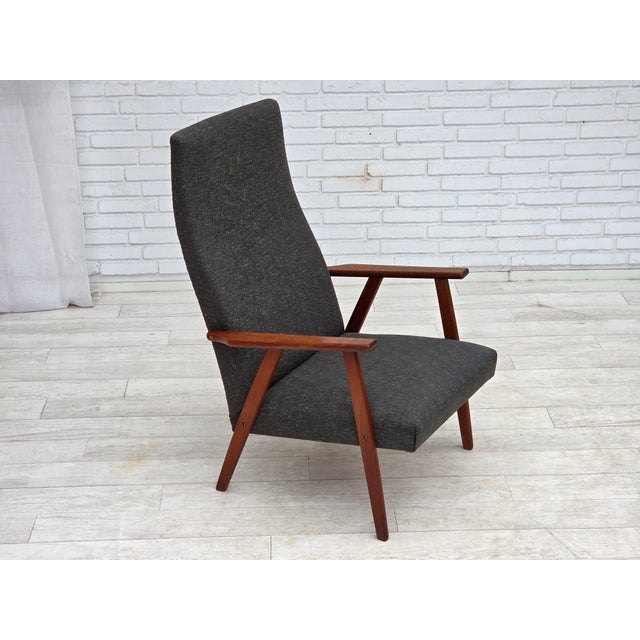 1970s, Danish highback armchair. Original dark green/gray furniture fabric, teak wood armrests and legs. Original very...