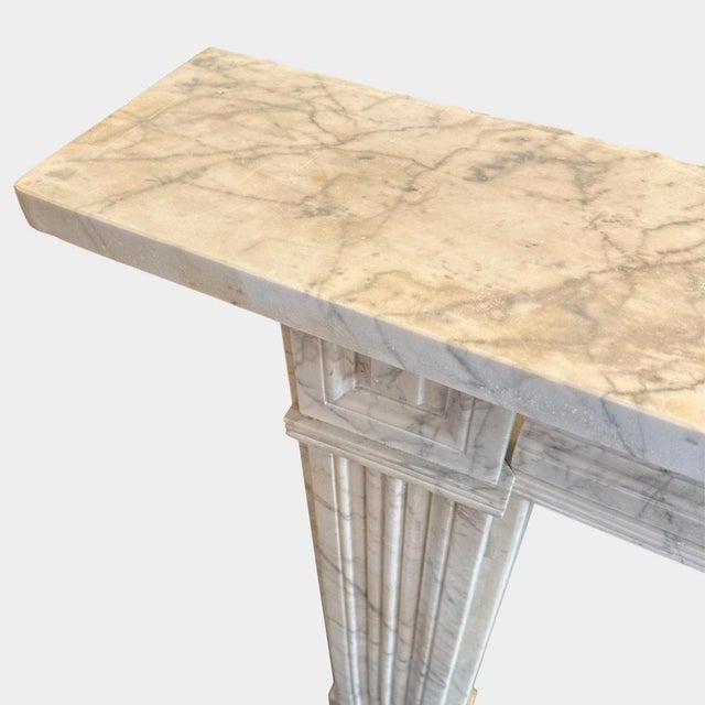An early 19th c Regency period antique fireplace in '' Pencil Vein " Italian Carrara marble. The reeded jamb panels to...
