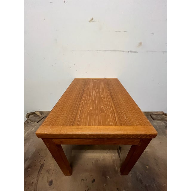 Mid-century modern end table. Teak. Legs are solid wood. Table top is veneer. Dimensions are 21-3/4” W x 15-5/8” D x...