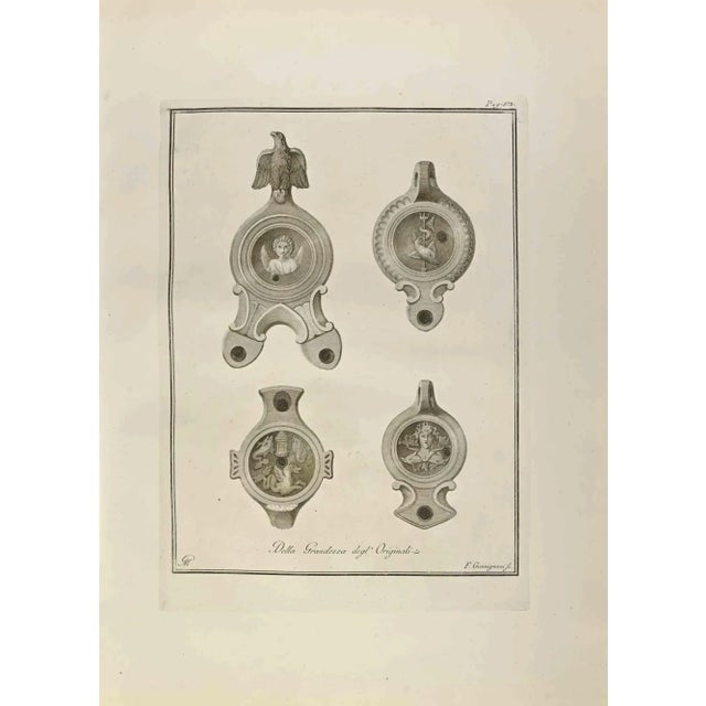 Oil Lamp with Medusa, Cupid and Poseidon from "Antiquities of Herculaneum" is an etching on paper realized by Francesco...