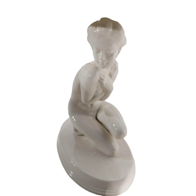 White ceramic table lamp in the form of nude female on oval white ceramic base. The lamps in good working condition, the...