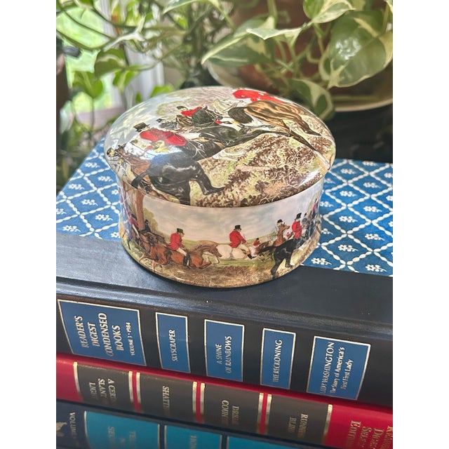 This is an English bone china lidded trinket or jewelry box by Newhall Staffordshire, decorated with a traditional...