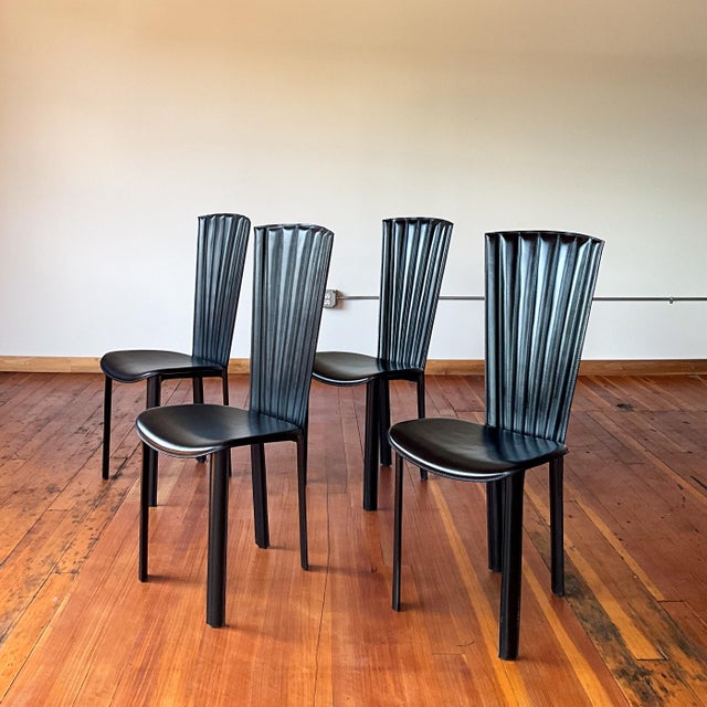 Black leather showstopper dining chairs in excellent condition. Beautiful scalloped details on the backrests. Sossano Italy.