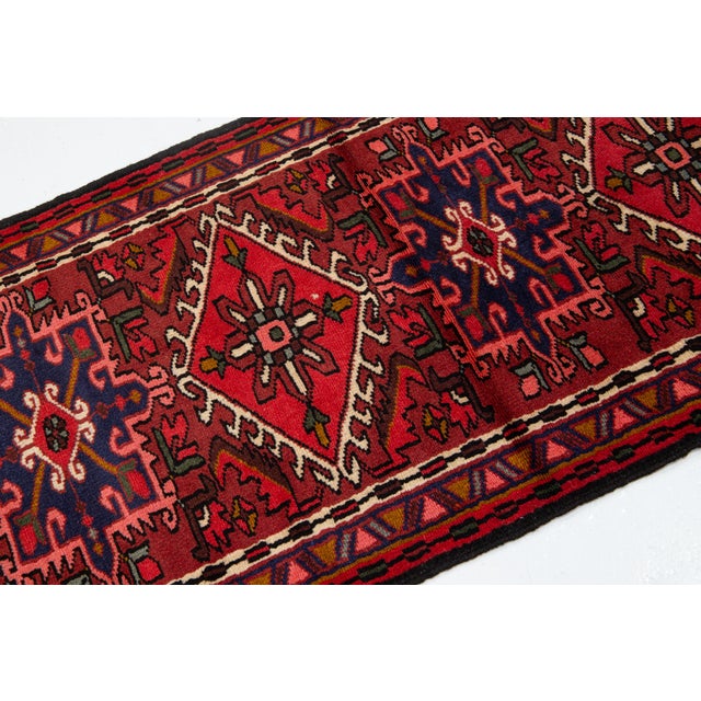 Enhance your space with this Vintage Persian Heriz Runner. Hand-knotted from durable wool, it showcases iconic geometric...