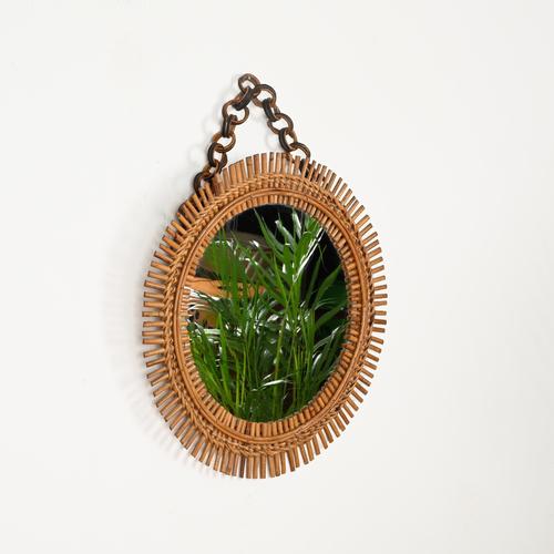 Wonderful French Riviera style round mirror with chain in bamboo, curved rattan, and hand-woven wicker. This charming...
