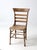 An antique American country chair dating to the late 19th to early 20th century, featuring a shaped ladder back with...