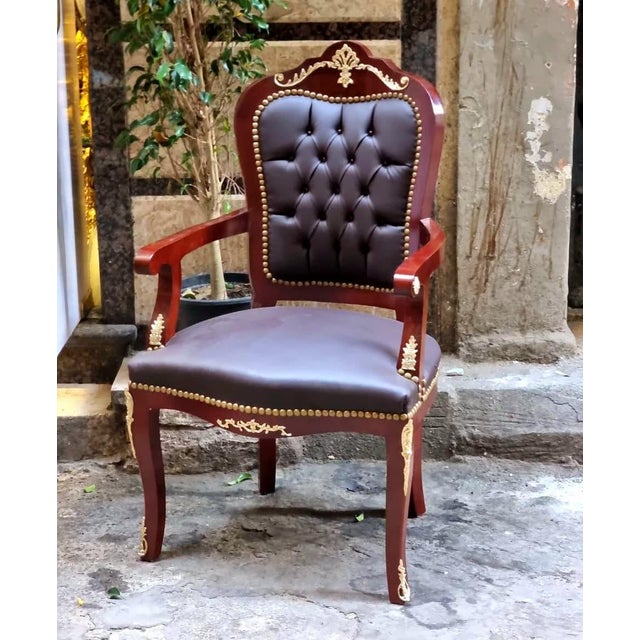 Add timeless sophistication to your interior with this elegant French-style armchair. Crafted from solid wood and...