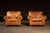 Handsome pair of full-grain brown leather club chairs built with the familiar weight and presence of classic English...