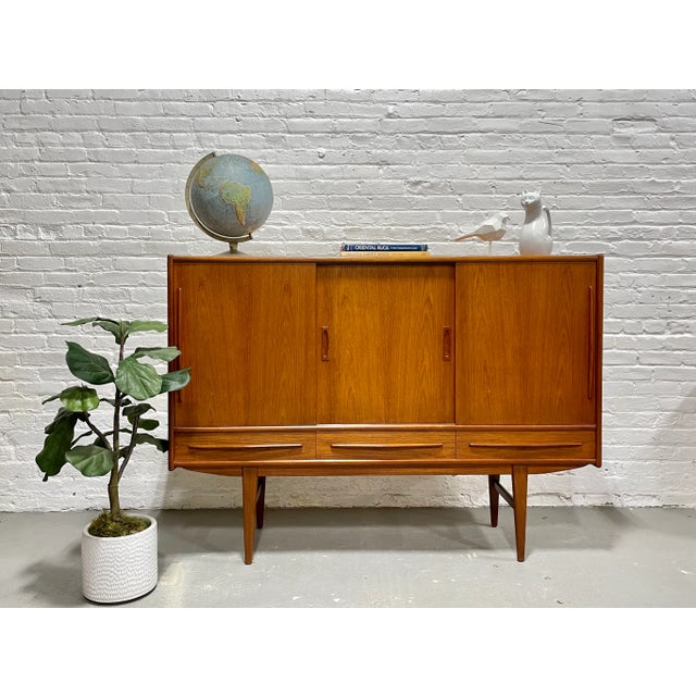 Stunning Mid Century Modern Danish Teak Highboard Credenza / Sideboard, c. 1960's. This incredible piece is gorgeous in...