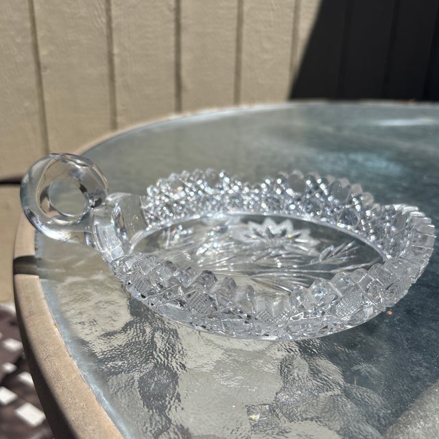 This piece is an antique clear glass handled nappy bowl from the McKee Glass Company Innovation line. Introduced around...