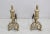 Pair of andirons in the Napoleon III style in bronze and iron. They display a torch in the upper part and a decoration of...