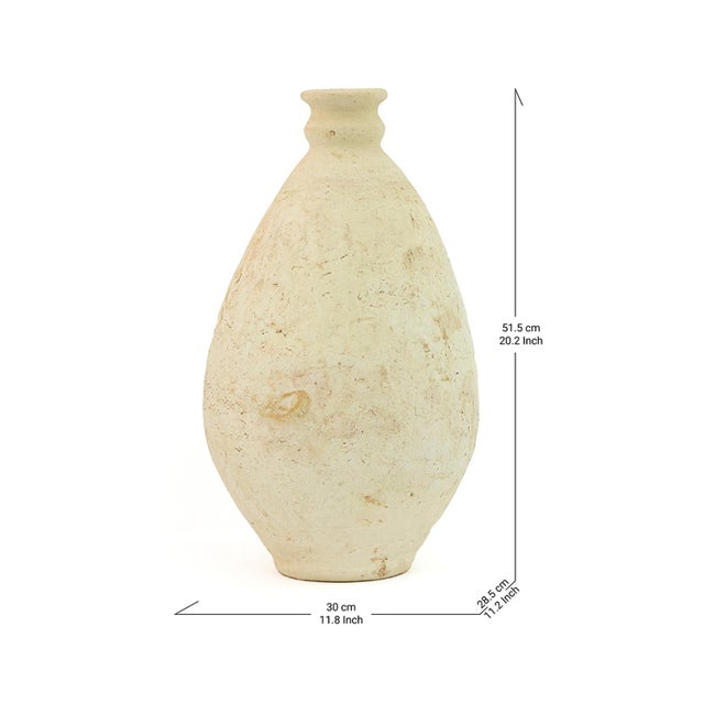 A graceful teardrop silhouette rises to a small flared neck in this Tamegroute vase, its surface left raw and unpolished...
