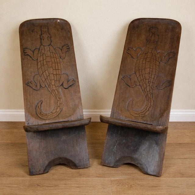 Central africa, circa 1950: pair of carved exotic wood chairs a rare and expressive pair of chairs from central africa,...