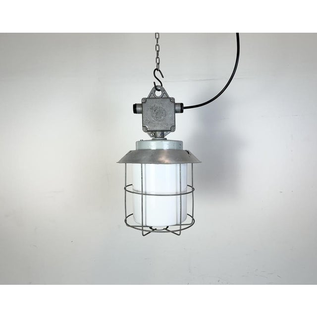 This Industrial hanging light was made by Elektrosvit in former Czechoslovakia during the 1970s. It features a cast...
