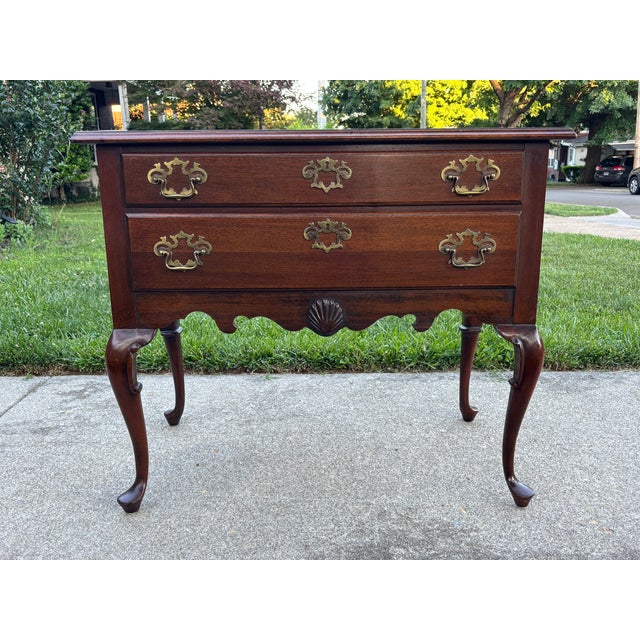 A Queen Anne style lowboy chest, no branding mark. Made in the USA in the mid-late 20th Century. Solid mahogany with brass...