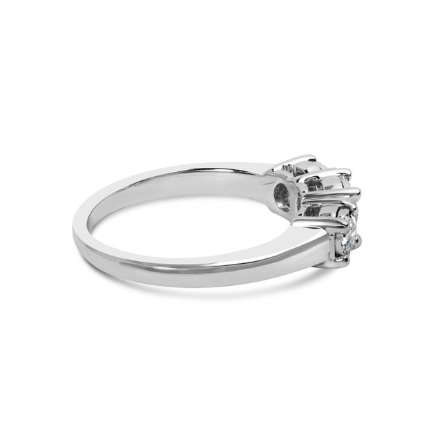 Crafted with 14K white gold, this radiant ring marries modern elegance with timeless charm, featuring a trio of lab-grown...
