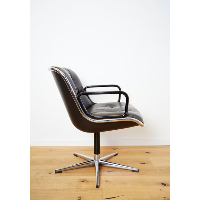 Condition: Upholstered in dark brown leather. The leather on the seat shows moderate patina. Swivel base. Charles Pollock...