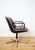 Condition: Upholstered in dark brown leather. The leather on the seat shows moderate patina. Swivel base. Charles Pollock...