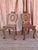 An exceptional matched pair of 18th century English scrubbed mahogany hall chairs. Intricate and graceful carving on the...