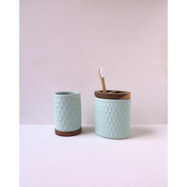 A ceramic and wood bathroom vanity set, a two (2) piece set. Set appears to have never been used. Pieces include a...