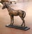 This elegant antique bronze sculpture depicts a finely modeled horse standing at rest and is signed Christophe Fratin, one...