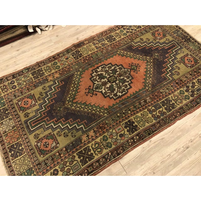 This is a vintage Turkish Oushak rug from the 1960s. The piece was hand-knotted.