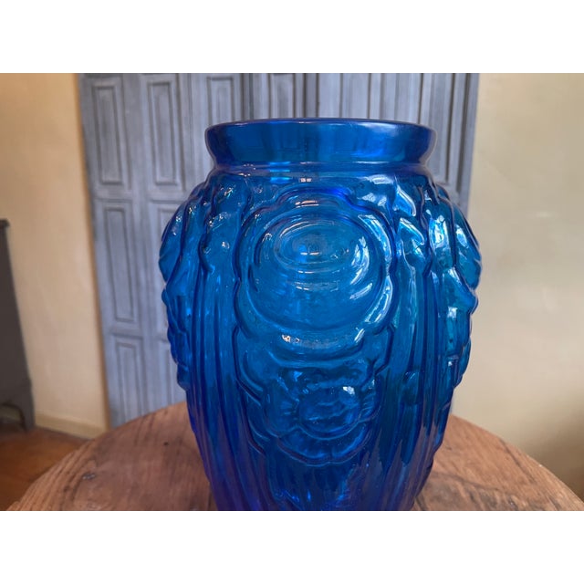 A stunning cobalt blue vase from the 1930s Art Deco period in France. The vase is decorated with flowers and asymmetrical...