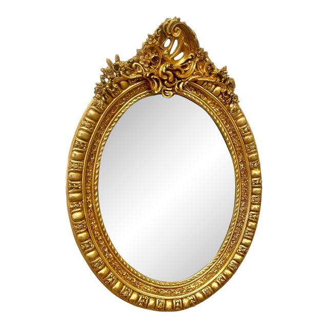 Oval Wall Mirror With Floral Center Detail & Gold Leaf Frame For Sale